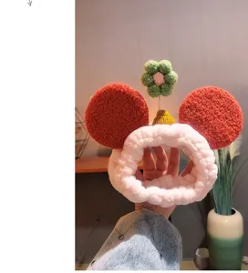 Cute plush face washing headband with red Mickey ears and green flower for women daily skincare.