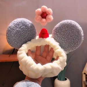 Cute plush Mickey ears headband for women, fluffy white spa makeup hair band with pink flower.