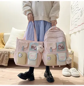 Pink multi-pocket backpack and tote bag set, cute campus style student bookbag detail view.