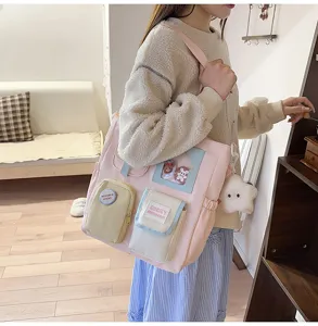 Detailed view of the cute pink multi-pocket canvas shoulder bag with lovely plush star charm.