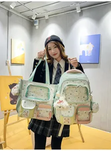 Details of stylish student color-blocking backpack and tote bag set with cute star patterns.