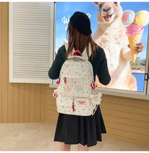 Korean style star print school backpack detail view with transparent pocket and cute plush pendant.