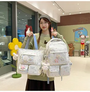 Detailed view of sweet star print school backpack set with cute plush charms and multiple pockets.
