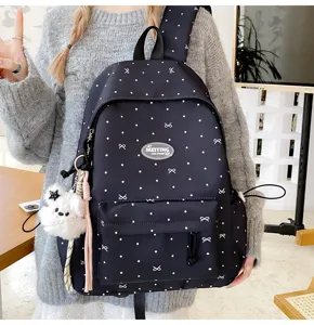Detailed view of a Japanese style polka dot girls backpack with cute ribbon motifs and plush charm.