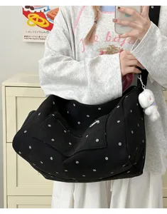Black corduroy polka dot bag detail showing soft fabric texture and large capacity.
