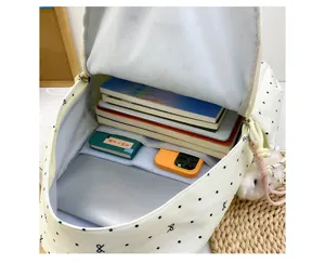 Detailed view of the large capacity canvas backpack interior, organized storage for books.