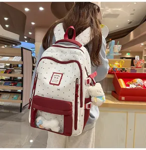 Sweet style white polka dot canvas ita bag with clear window and cute plush bear pendant.