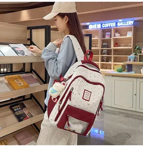 Detailed view of the cute white red polka dot ita backpack with clear window and plush toy.