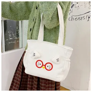 Cute white corduroy tote bag with red glasses cartoon design for daily lunch box storage.