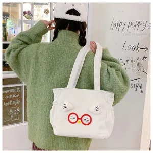 Detail shot of cute corduroy tote bag with plush cat ears and red glasses, lifestyle scene.