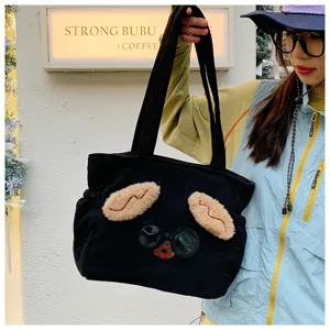 Cute black corduroy lunch bag detail view, featuring lovely puppy ears and fun glasses decor.