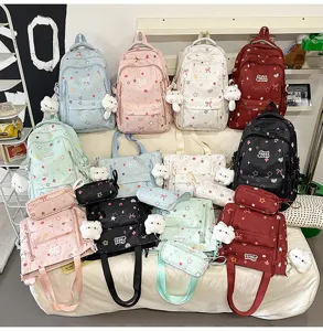 Cute school backpack set detail view featuring star prints, bows and plush pendants.