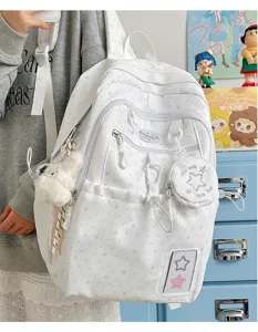 White star pattern student backpack with cute mini pouch and charms for daily school commute.