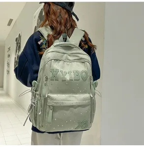 Light green canvas backpack for school students with cute stars and letters design, large capacity.