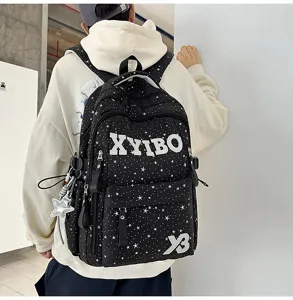 Detailed view of black canvas backpack with white star pattern and sporty straps for daily use.