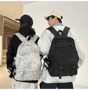Detailed view of cool camo couple backpacks worn by models, featuring cute cat plush charms.