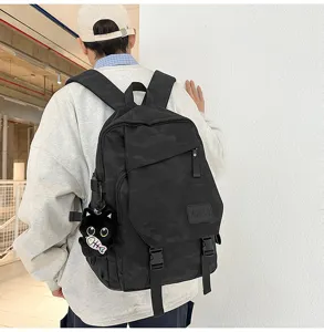 Detailed view of the black camo backpack with cute cat pendant for casual daily use.