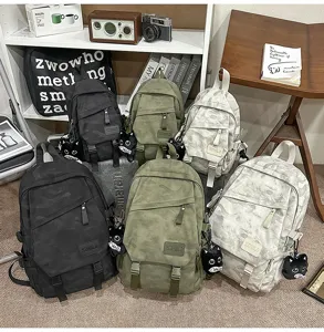 Lightweight casual camo backpack with dark pattern and cat pendant for daily use.
