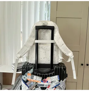 White star pattern backpack with luggage strap, large capacity school bag for students.