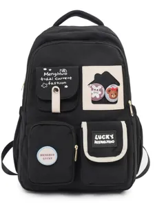 Black canvas school backpack with contrast color pockets, multiple compartments and cute badges.
