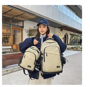 Outdoor lightweight hiking backpack and small chest bag detail showing durable beige fabric.