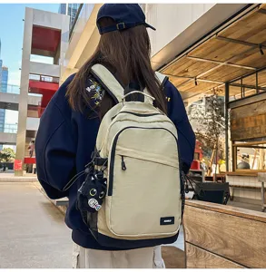 Casual commuting backpack in beige with black base, versatile daypack for outdoor and travel.