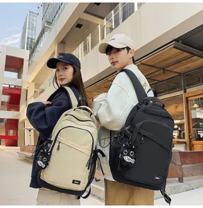 Casual waterproof backpack for daily commuting, school, and outdoor travel with cute pendant.