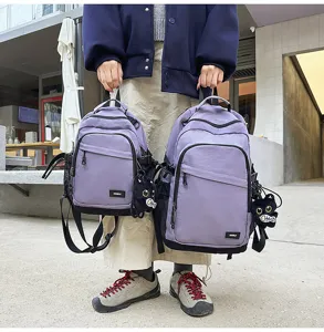 Water-resistant casual backpack for daily commute and outdoor hiking with cute pendant.
