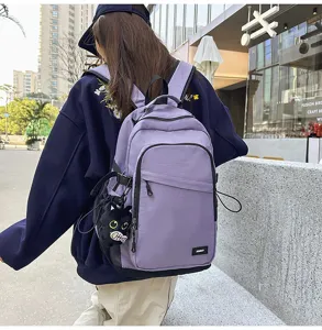 Casual purple canvas backpack for daily commute and outdoor travel with cute cat pendant.