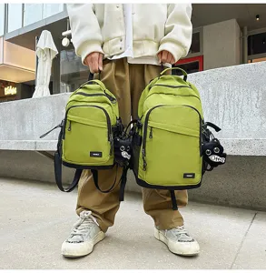 Detail view of casual outdoor waterproof backpack in two sizes with cute cat pendant.