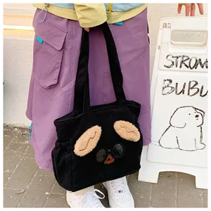 Black corduroy lunch tote bag detail showing cute 3D plush puppy ears and sunglasses design.