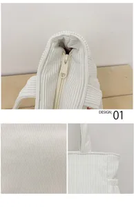 White corduroy lunch bag detail view, showing smooth zipper, sturdy handle and fine fabric texture.