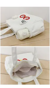 Corduroy lunch tote bag detail, cute cartoon embroidery, white canvas bag with pocket.