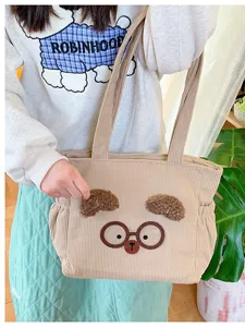 Cute corduroy lunch bag with cartoon bear face design, practical portable tote handbag for daily use.