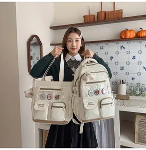 Cute creamy white canvas student backpack and tote bag set with multiple pockets and badges.