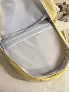 Korean style yellow backpack for students, spacious interior compartment with smooth zipper.