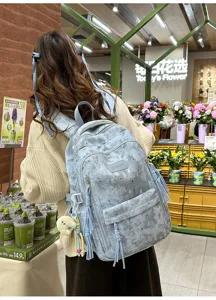 Korean style minimalist light blue backpack with star moon pattern and cute tassels for daily use.