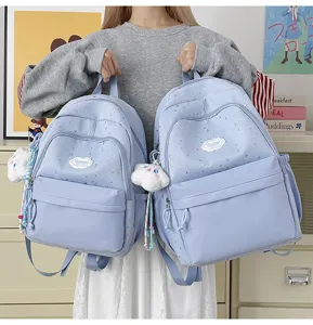 Cute star print sweet school style light blue backpack with cloud patch and charm details for use.