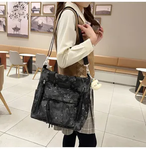 Detailed view of the Japanese style star print canvas shoulder tote bag with front zipper pockets.