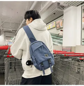 Casual nylon crossbody chest bag in blue featuring a front pocket, zipper and logo patch.