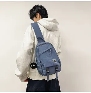 Unisex blue casual sling chest backpack with buckle straps and cute charm for daily use.