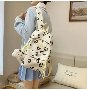 Detail view of a cute Korean style spot backpack with plush pendant and shoulder straps.