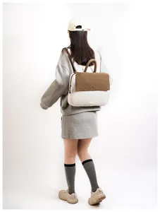 Detailed view of casual striped student backpack with brown flap and comfortable shoulder straps.