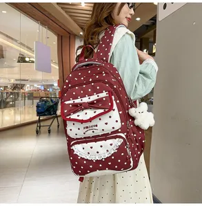 Joli sac à dos à pois pour filles avec nœud, bordure en dentelle et design charmant et stylé.