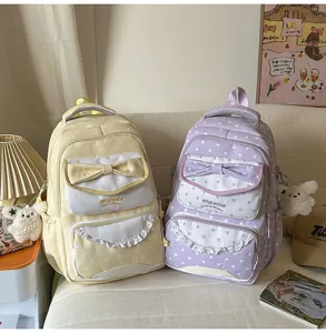 Sac à dos mignon de printemps pour filles, design à pois et nœud style étudiant chic.