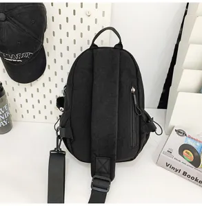 Detailed view of black unisex casual chest bag, featuring adjustable strap and side pocket.