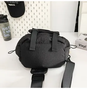 Detailed view of the black casual unisex crossbody chest bag, versatile design with straps.