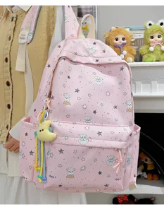 Detailed view of cute pink Japanese style student backpack with star pattern and moon pendant.
