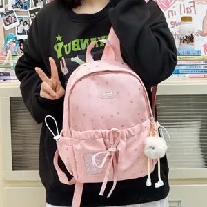Cute pink star pattern school backpack with fluffy charm and front pocket for daily outings.