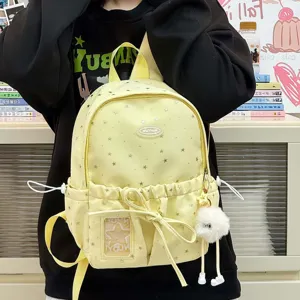 Cute yellow star print school backpack with fluffy keychain and clear pocket for students.